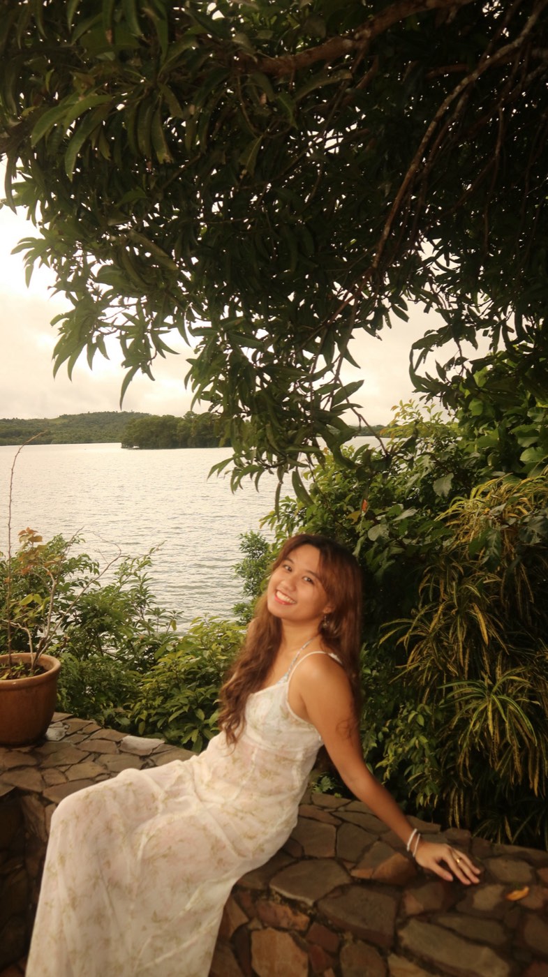 Elle smiling by a lake in the Philippines